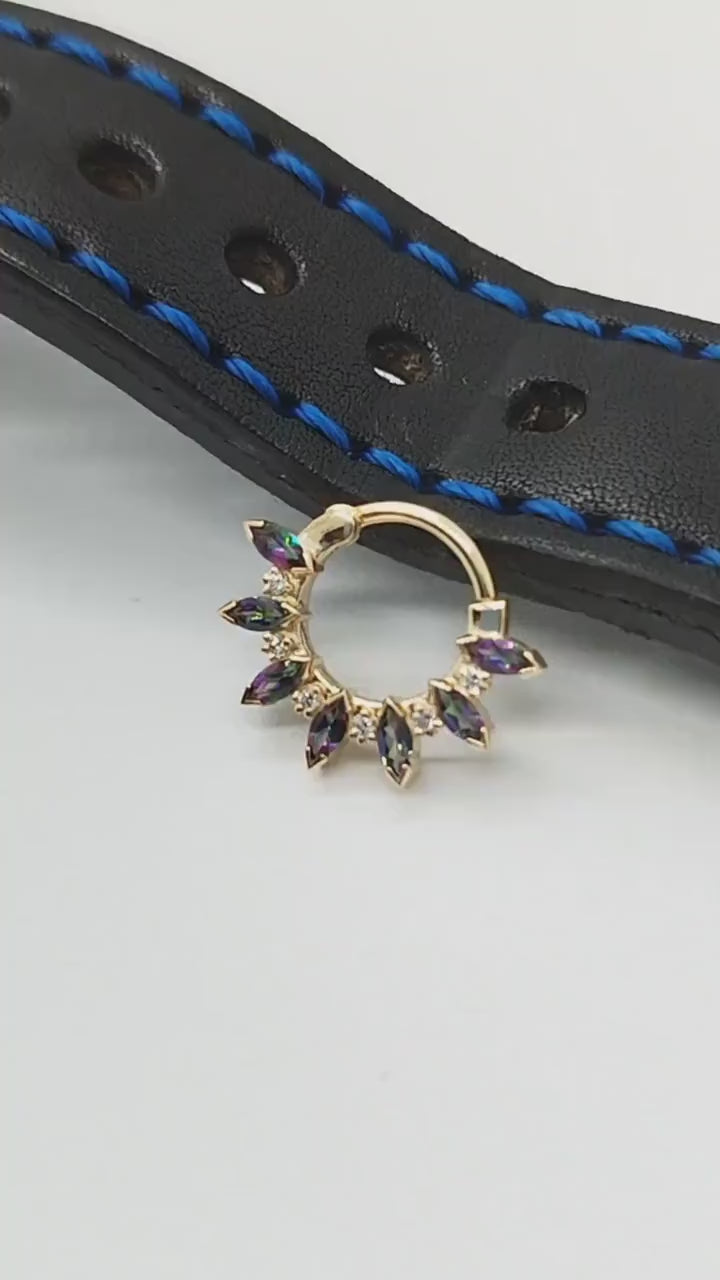 14k gold piercing craft, showcasing a sun-inspired mercury mystic topaz design and white diamonds